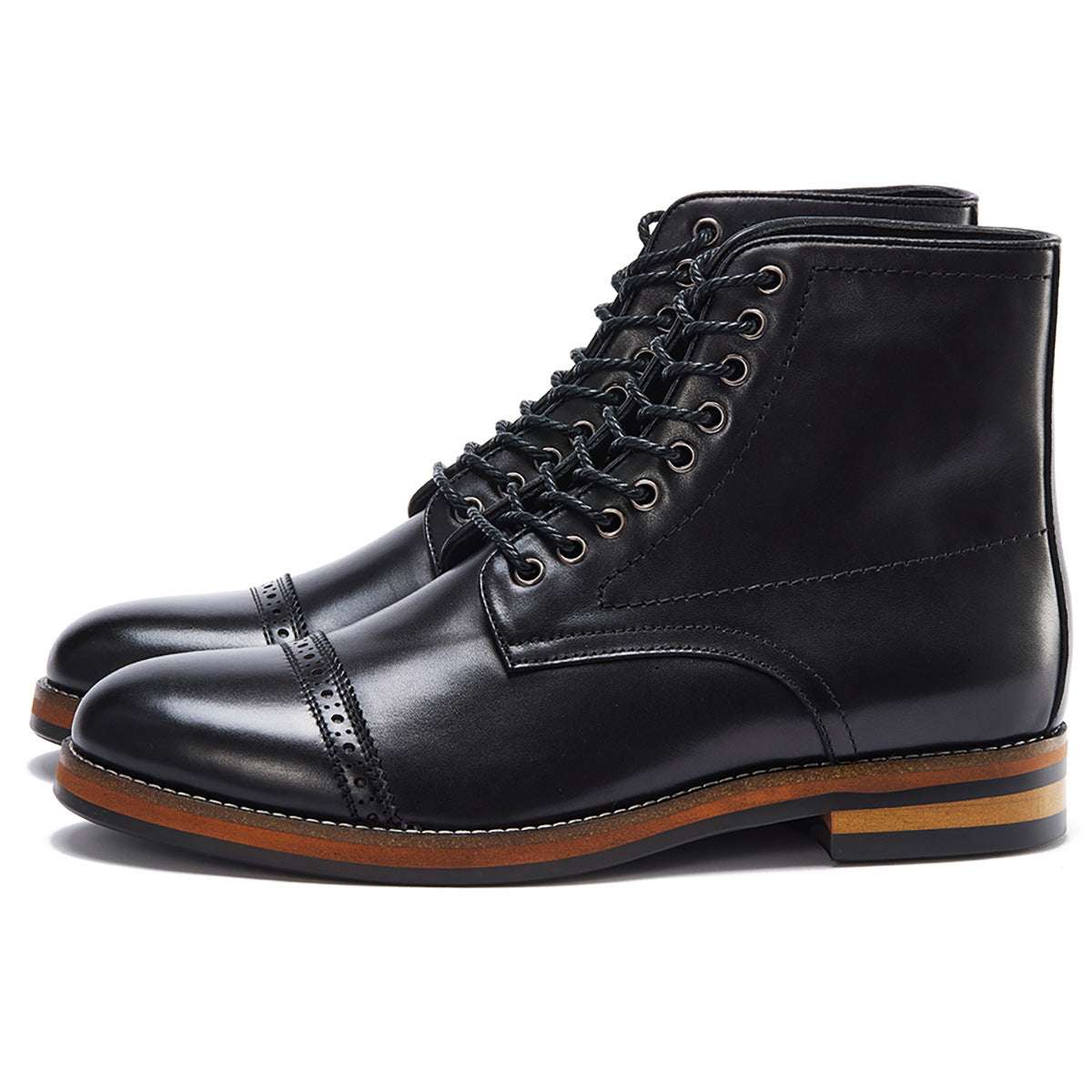 Pair of black leather boots with brown soles on a white background