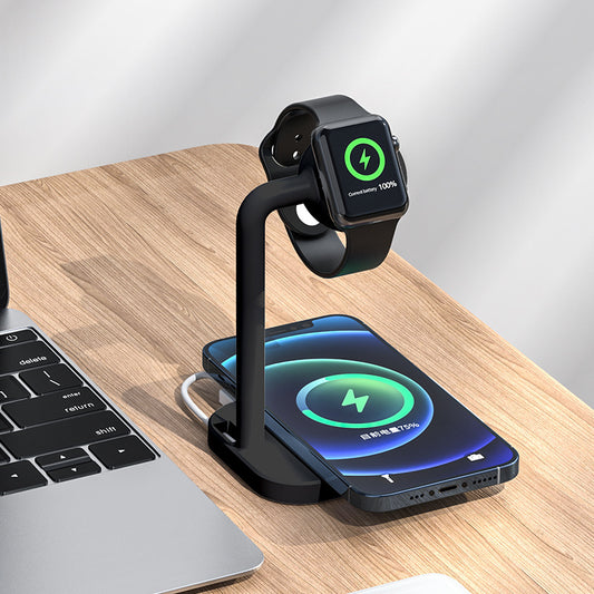 Multi-device charging stand with smartwatch, phone, and laptop on a wooden surface.