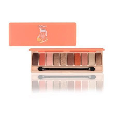 Makeup palette with eyeshadows and brushes on a white background