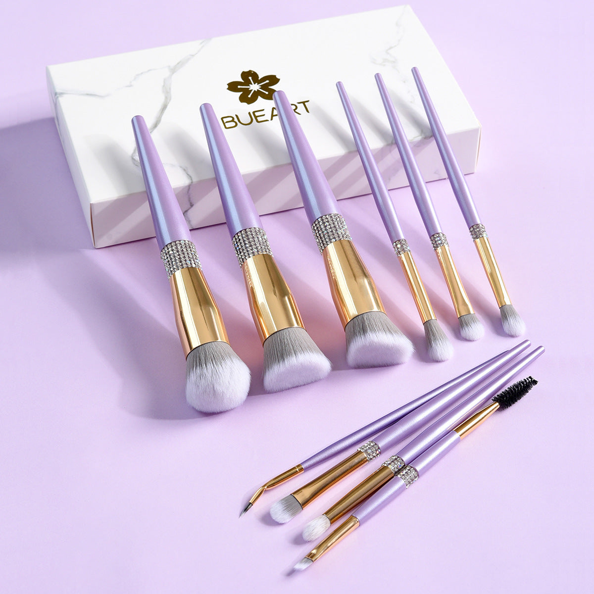 Set of makeup brushes with purple handles and gold accents on a light purple background, featuring the BUEART brand.
