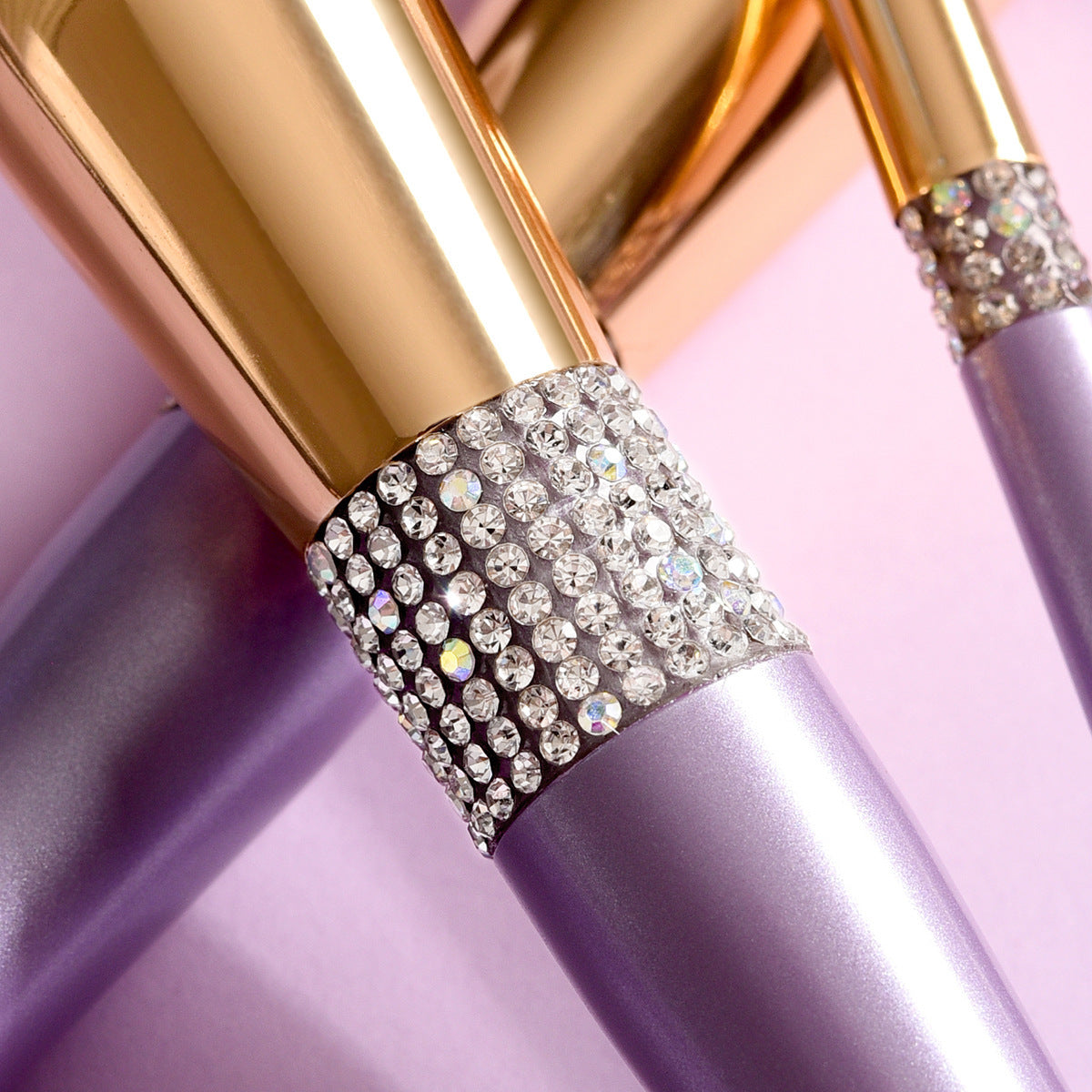 Lipstick with a decorative cap featuring crystals on a pink background