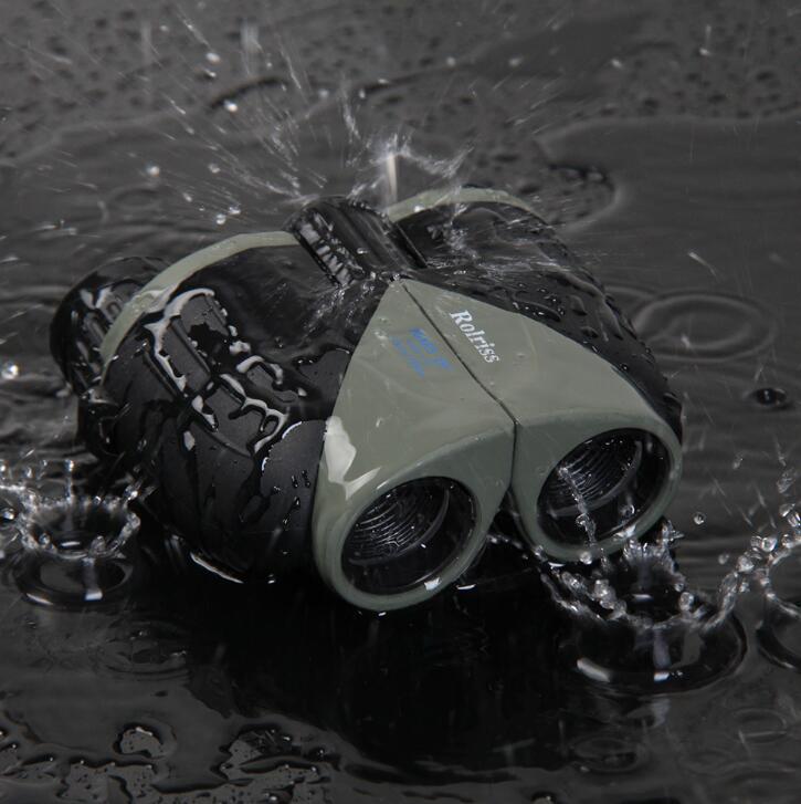 Binoculars splashing into water with 'Rays' branding visible