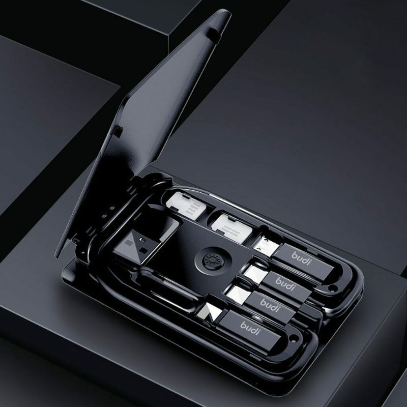 Black multi-tool with various components on a dark background