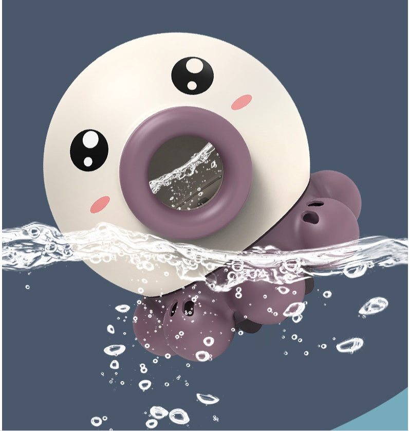 Donut-shaped toy with a face, partially submerged in water on a blue background