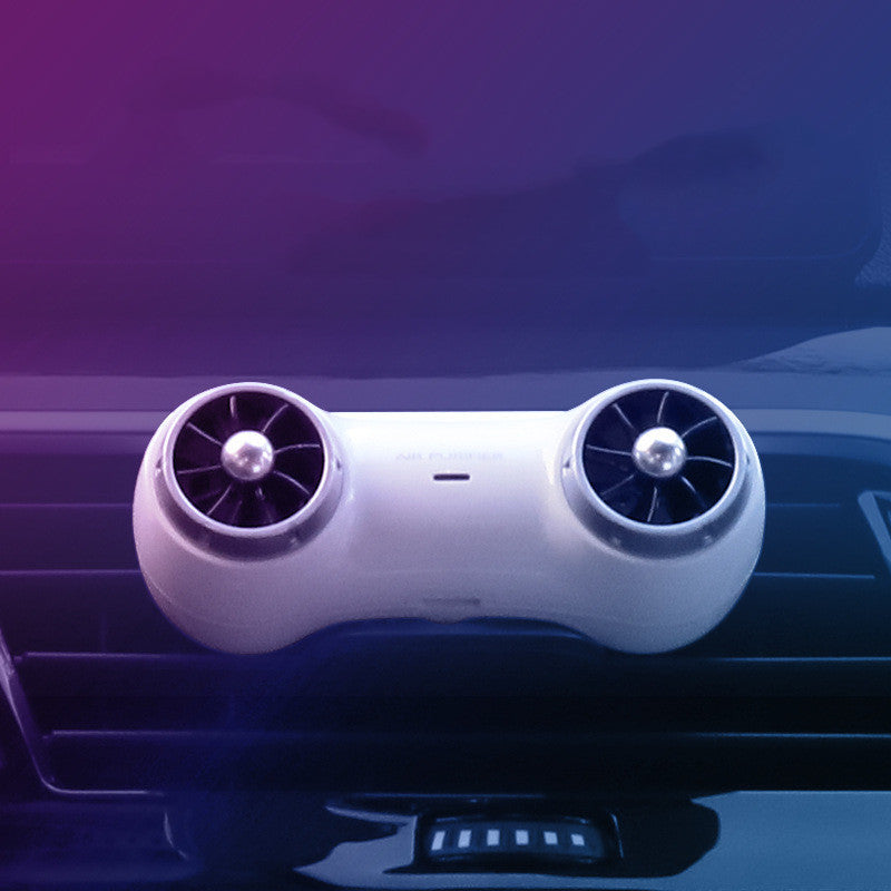 Car air freshener with dual fans on a car dashboard