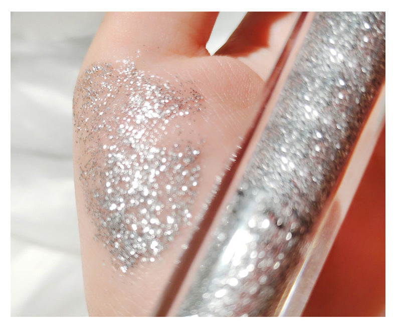 Close-up of a hand with silver glitter on a blurred background