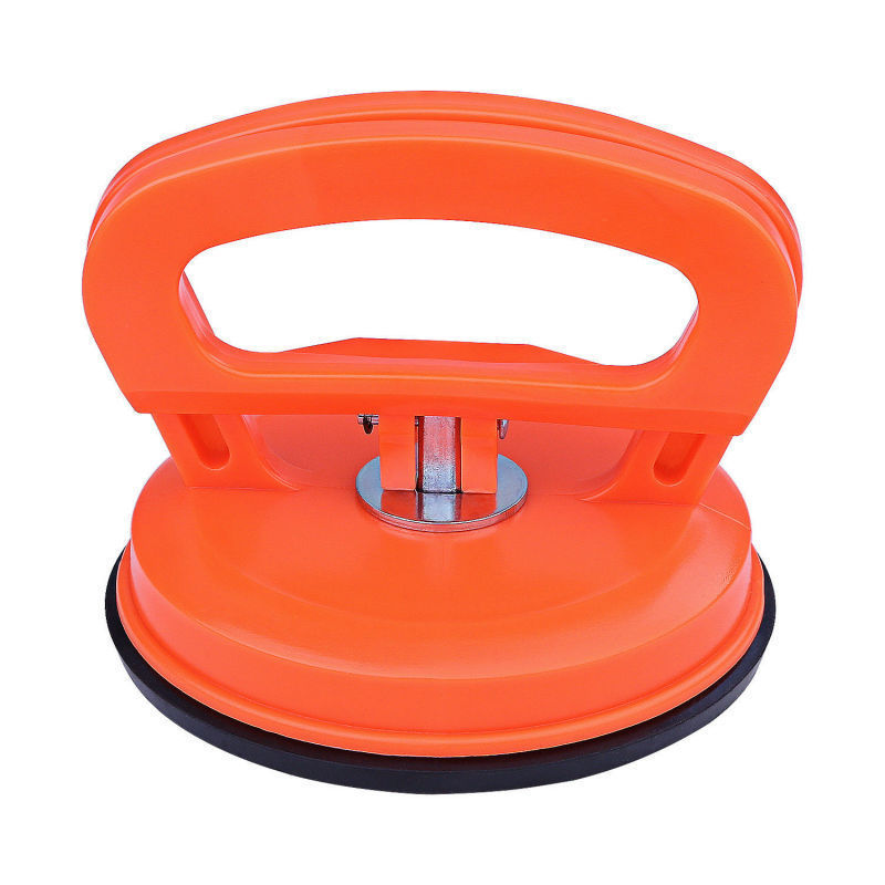 Orange suction cup tool with black base on a white background