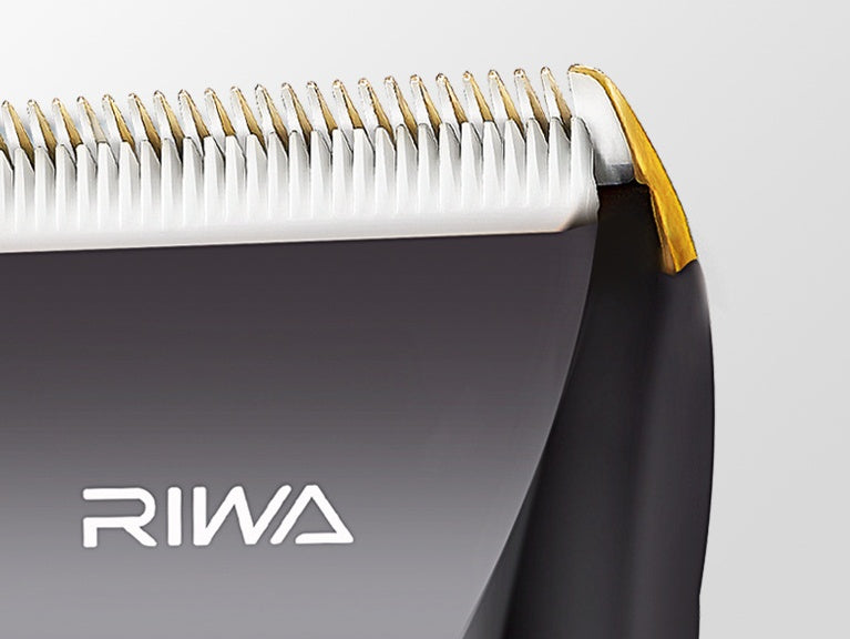 Hair clipper with gold accents and RIWA branding on a light gray background