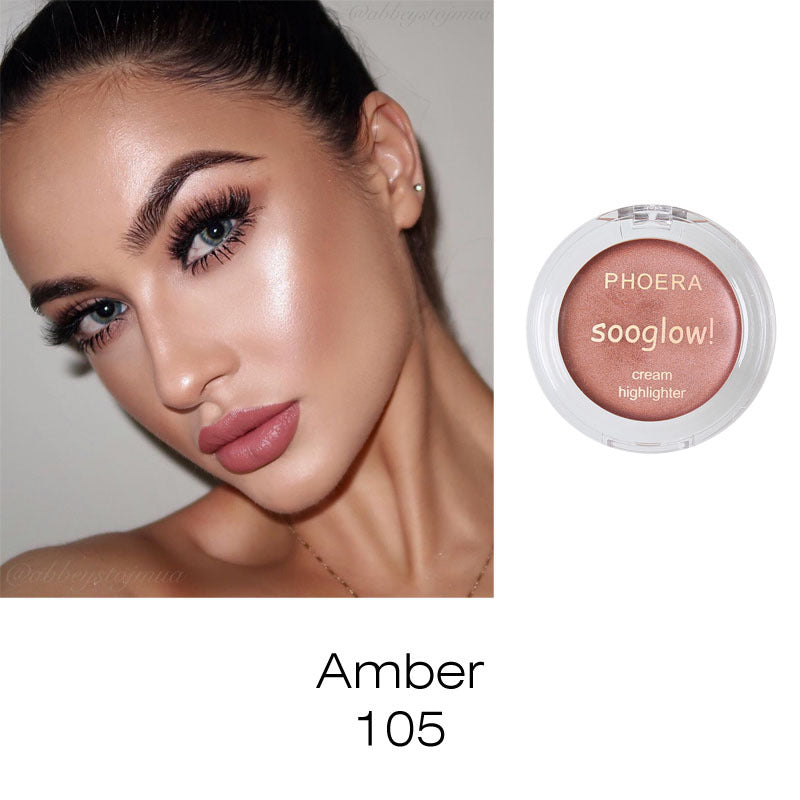 Amber-gold cream highlighter in a round plastic compact