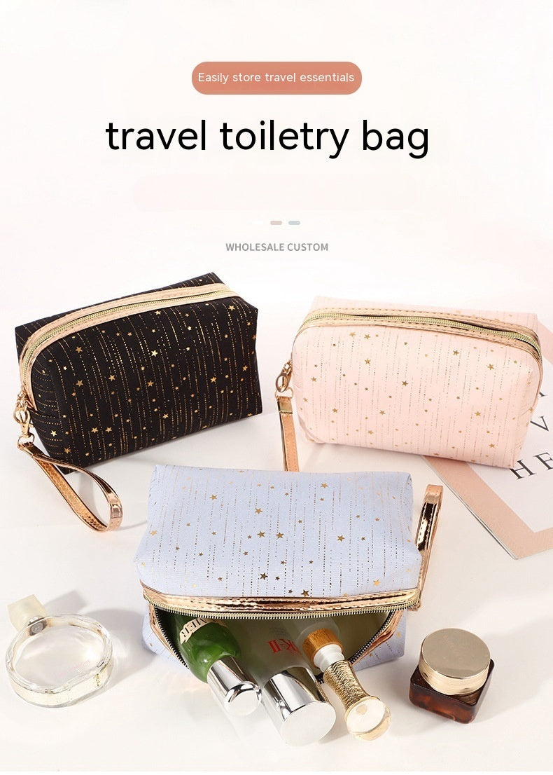 Star toiletry bags in black, light pink, and light blue with gold zippers