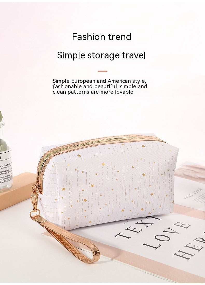 White octagonal star cosmetic bag with gold zipper and wrist strap