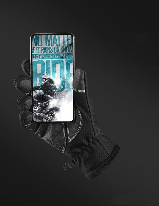 Hand wearing a black glove holding a phone with a motivational quote on a dark background