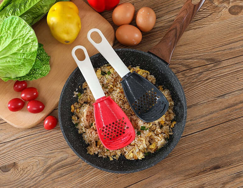Two perforated cooking spoons with white handles: red and black