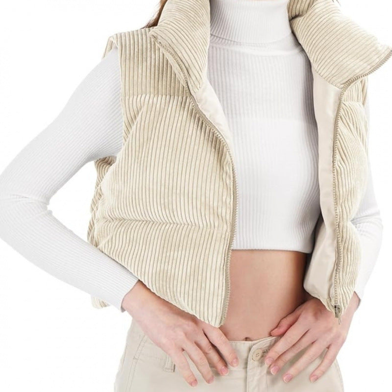 Beige corduroy vest over a white long-sleeve shirt on a white background