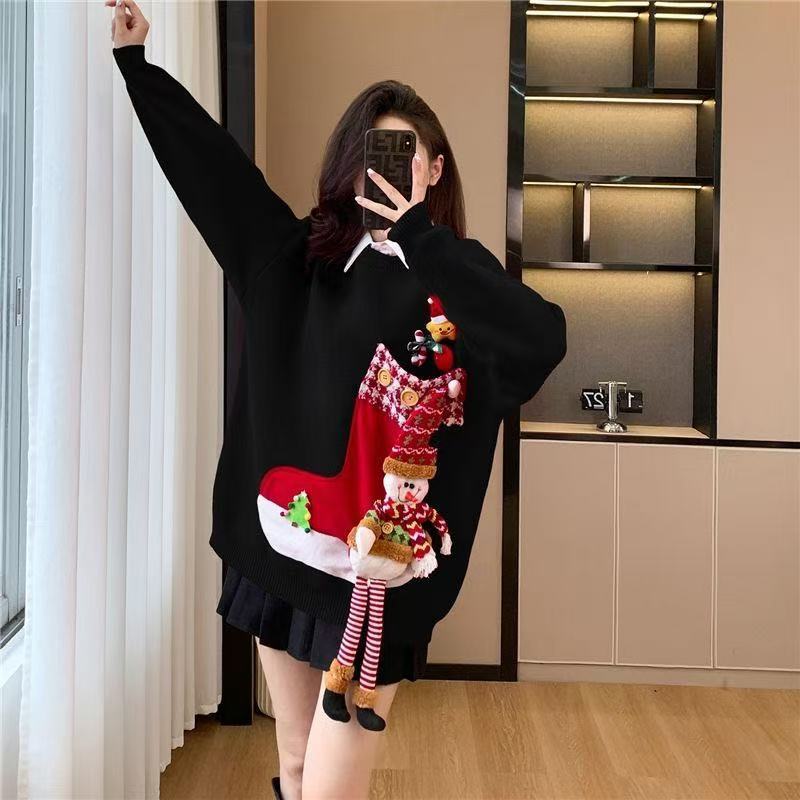 Person wearing a black sweater with a colorful Christmas-themed design in a room.