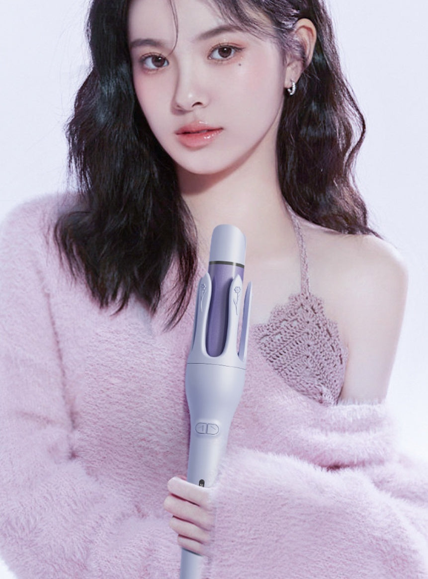 Woman holding a hair straightener against a light pink background