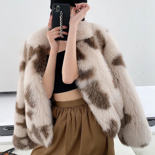 Person wearing a fur coat with a neutral background
