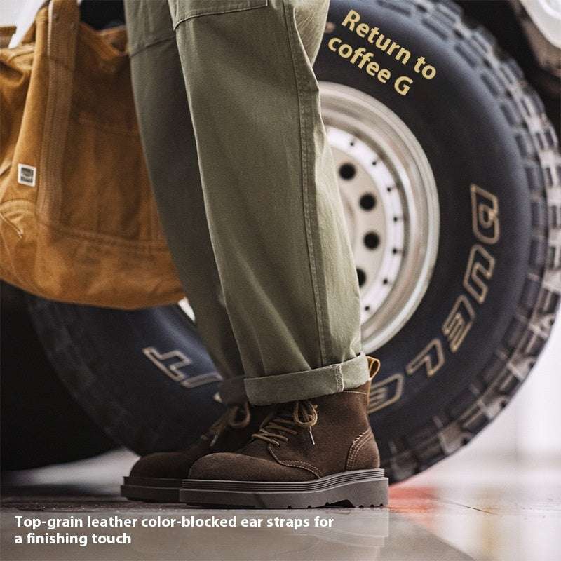 Person wearing brown boots with ear straps, standing next to a car tire.