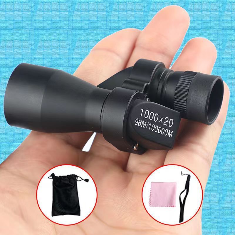 Hand holding a black binoculars with additional images of a carrying case, cloth, and strap on a blue background.