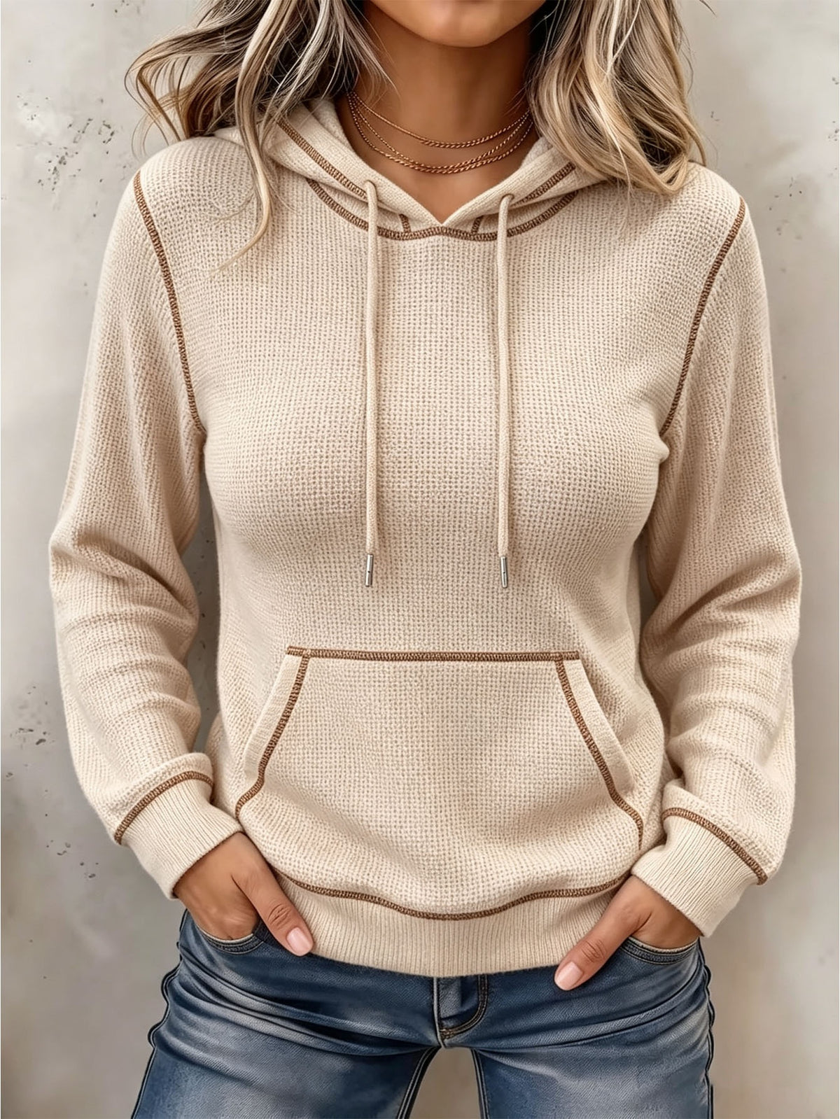 Beige long-sleeve hoodie with drawstring hood and front kangaroo pocket