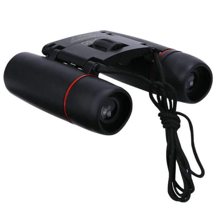 Black binoculars with orange lens openings and top focusing knob, side view