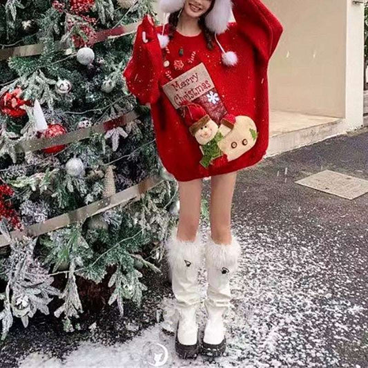 Person wearing a red Christmas sweater with a tree in the background