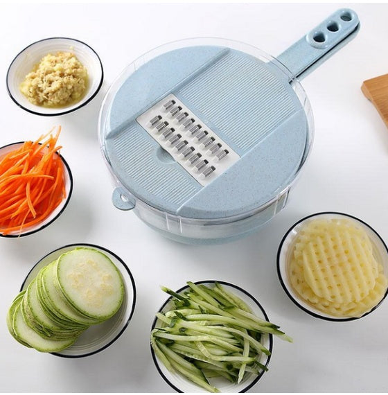 Blue round mandoline slicer with grater insert beside carrot and zucchini slices
