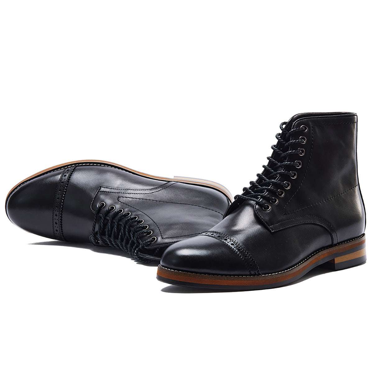 Pair of black leather boots on a white background