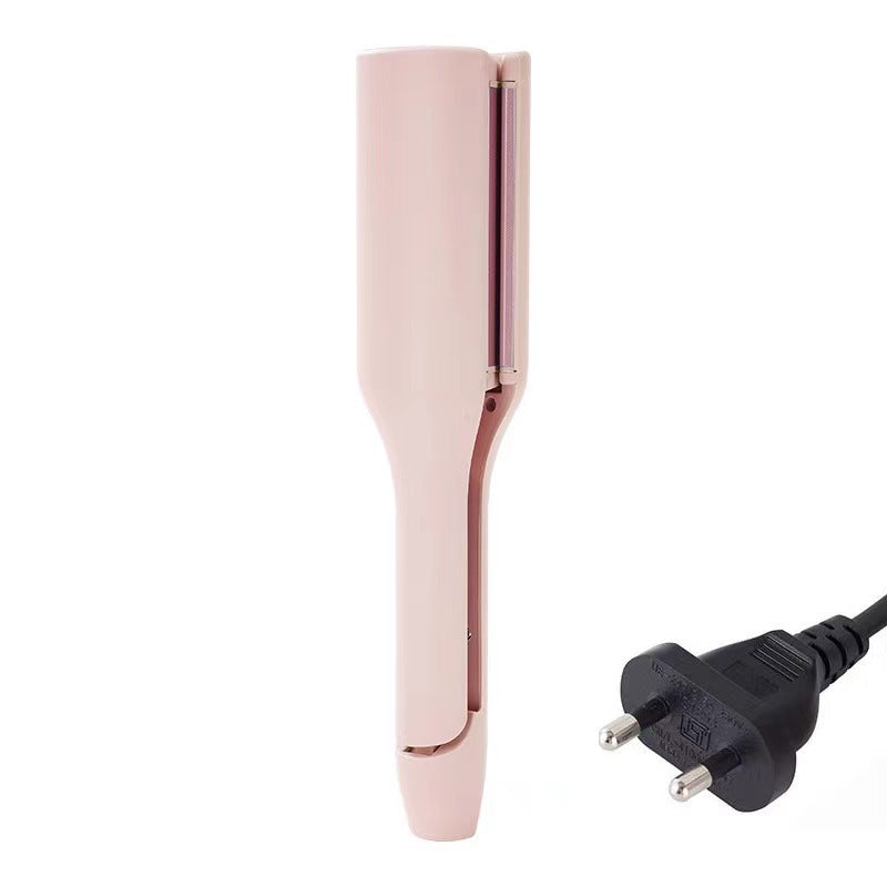 Rose gold hair straightener with a black plug on a white background
