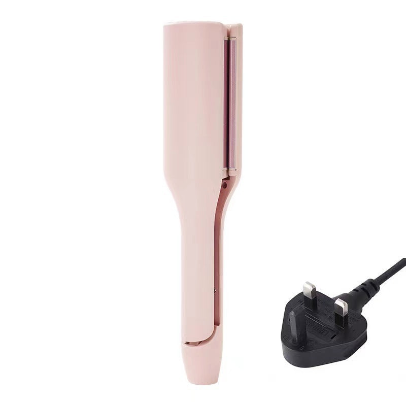 Rose gold hair straightener with UK plug on a white background