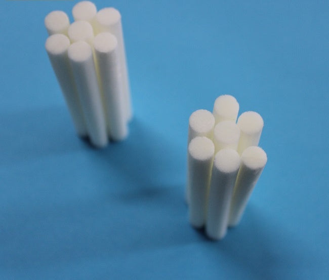 Two groups of white cylindrical objects on a blue background