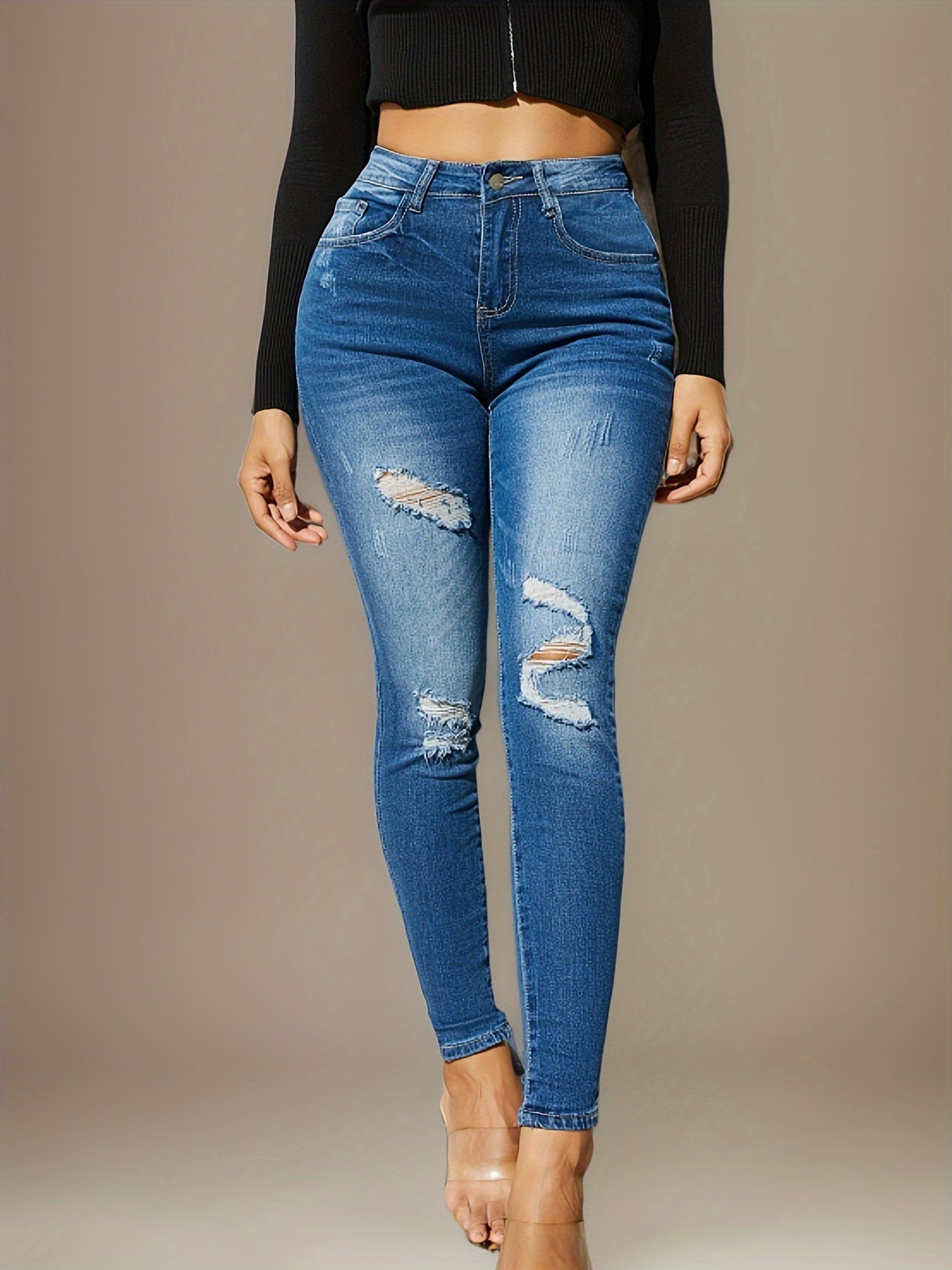 Light blue high-waist skinny jeans with ripped patches at thighs