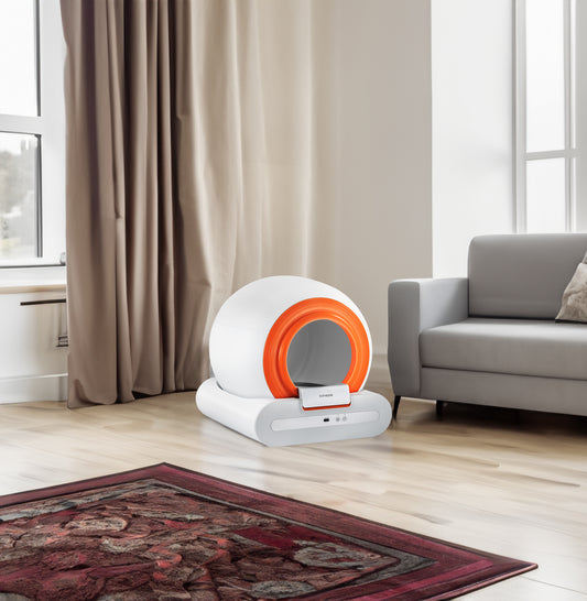Self-cleaning cat litter box with orange entry ring and gray base