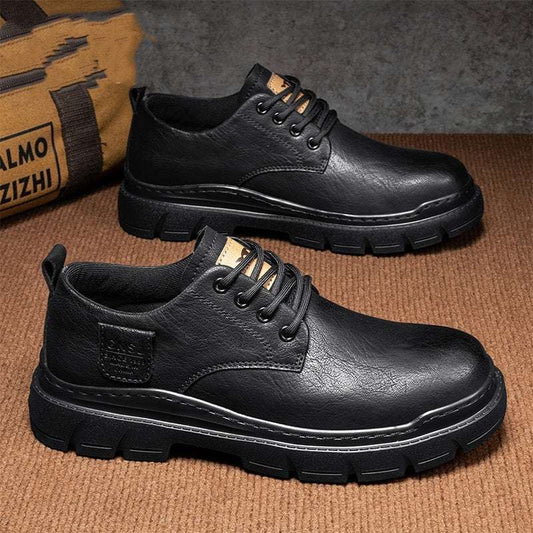 Black leather shoes on a textured brown surface with a blurred background
