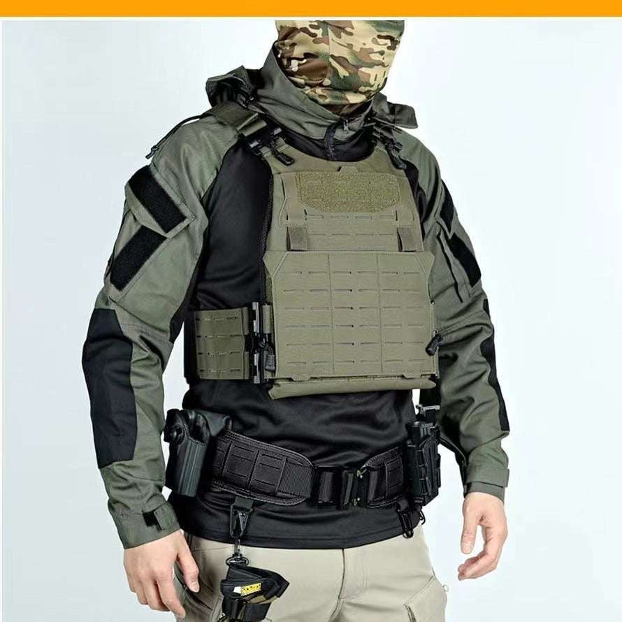Person wearing tactical gear including a vest, helmet, and weapons on a light gray background