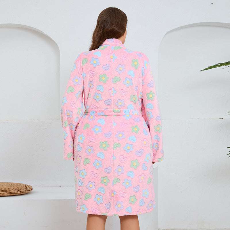 Person wearing a pink floral robe against a white background