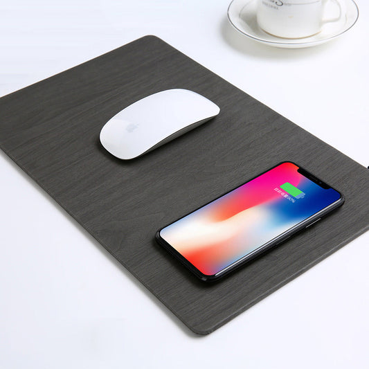 Black mouse pad with a white mouse and smartphone displaying a colorful screen on a light gray background.