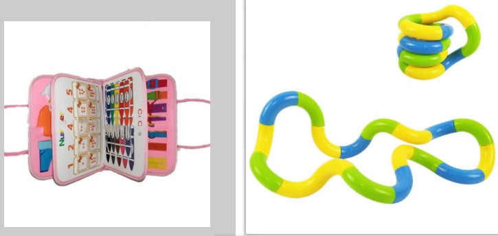 Pink children's book with colorful pages and a set of interlocking rings on a white background.