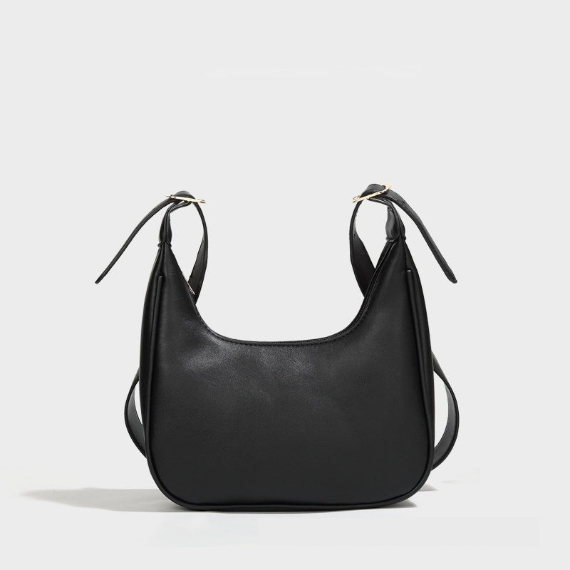 Black dumpling crossbody bag with curved front and tie strap handles