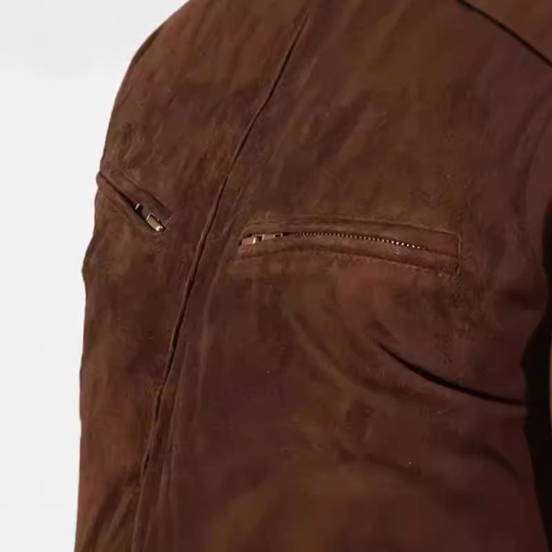 Close-up of a brown suede jacket with a zipper pocket on a white background