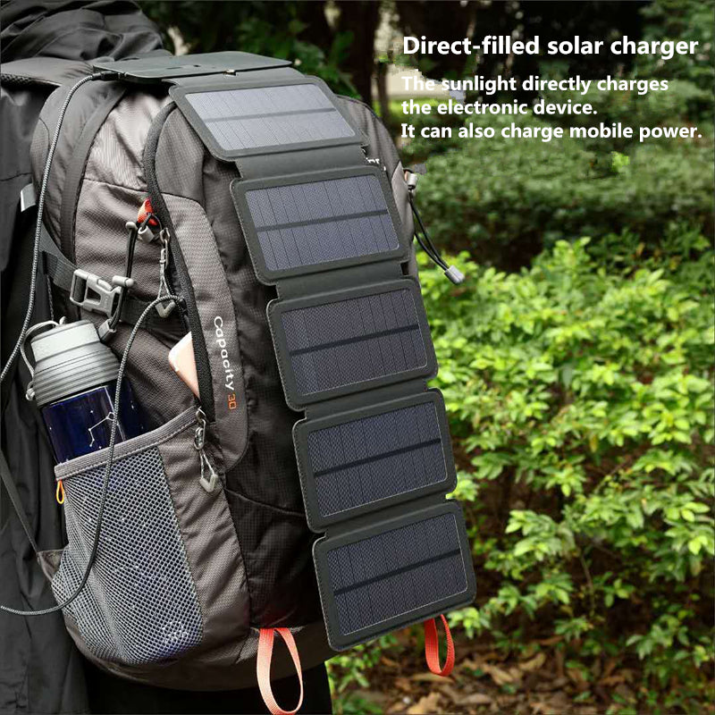 Foldable solar panel charger on gray backpack with stacked dark panels and cable