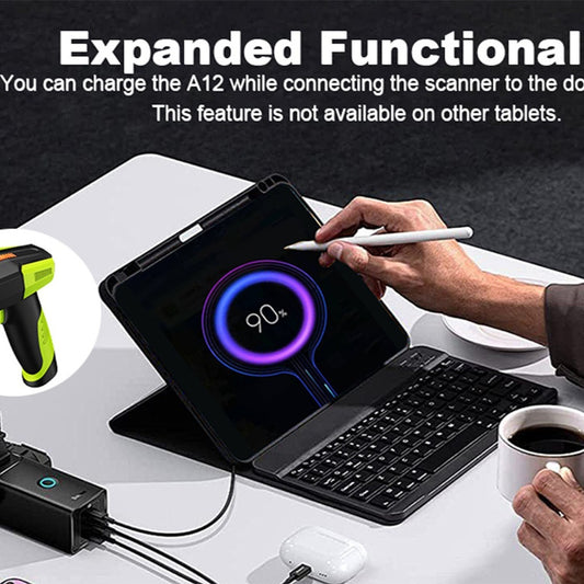 Person using a tablet with keyboard and stylus, connected to a scanner, on a desk.