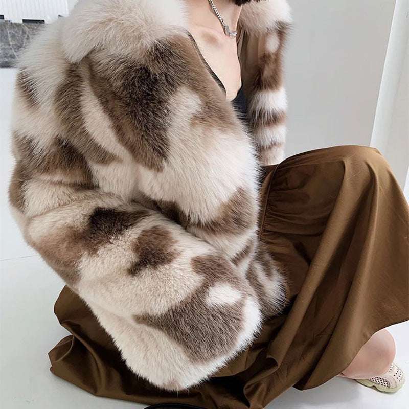 Person wearing a fur stole over a brown outfit on a white background