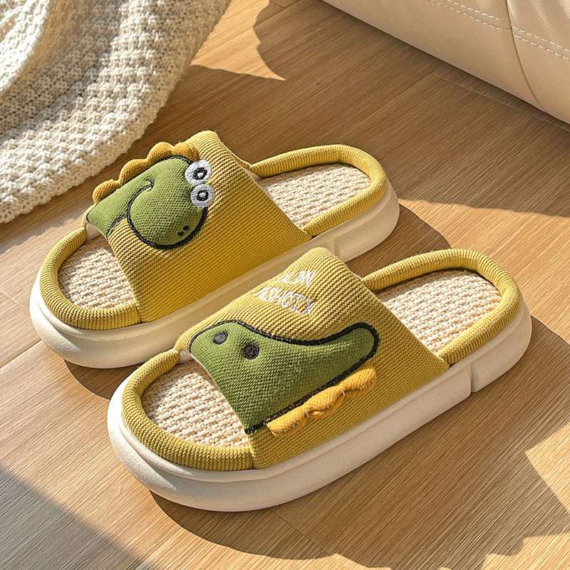 Linen cartoon dinosaur slippers, mustard yellow with green dinosaur graphic and white sole
