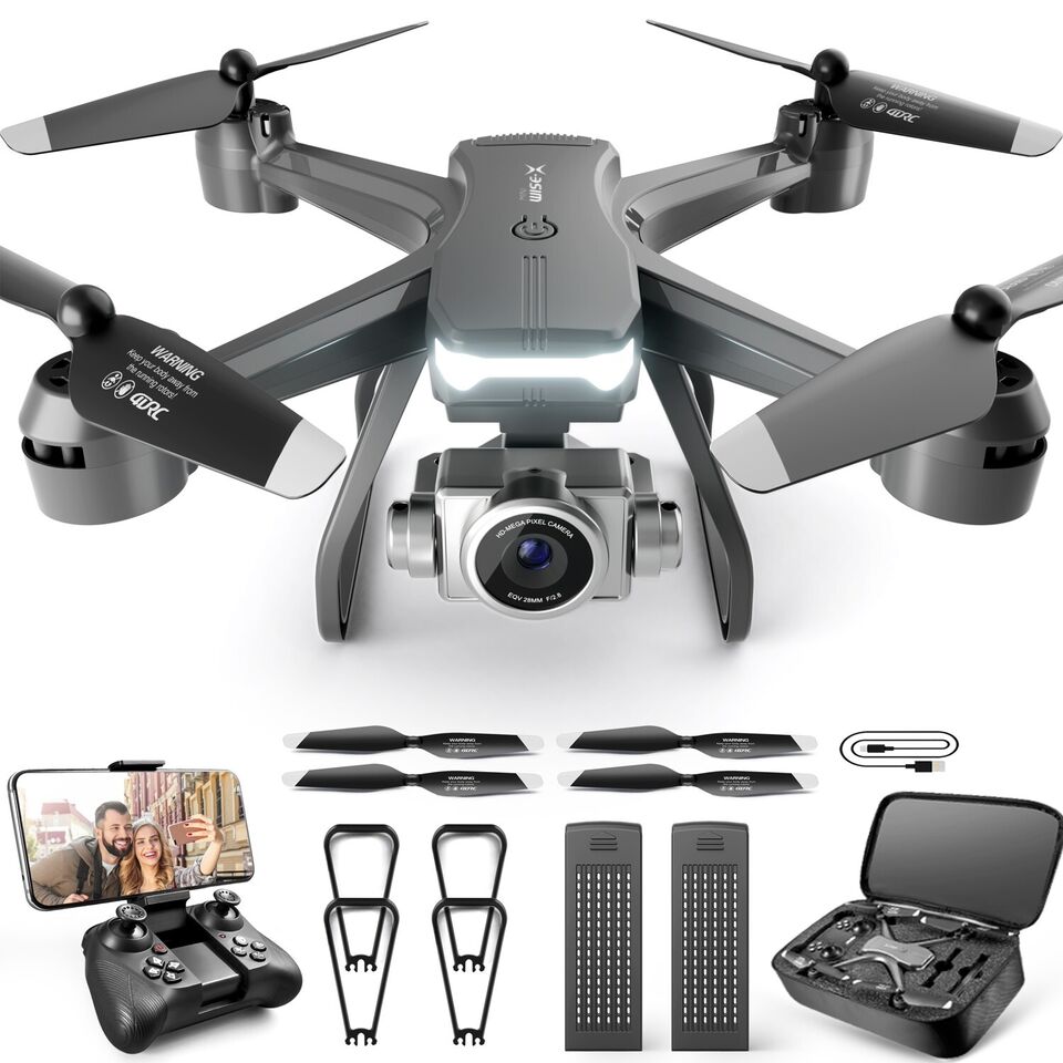 Gray quadcopter drone with four propellers and dual camera lens, plus controller and case