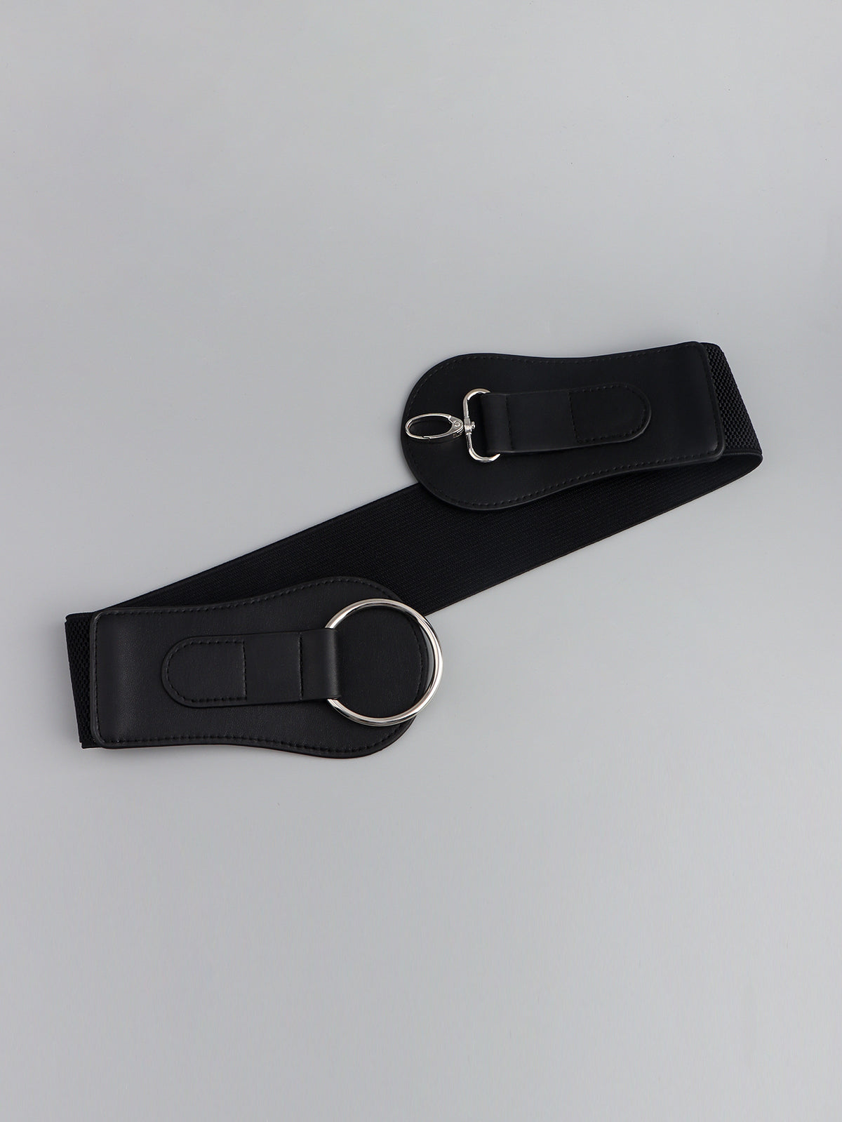 Black wide belt detail showing end buckle tab and oval ring in silver metal