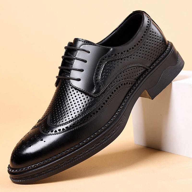 Black leather dress shoe on a beige background