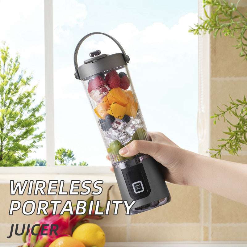 Wireless juicer cup with clear container, dark base, and top handle; fruit pieces inside.