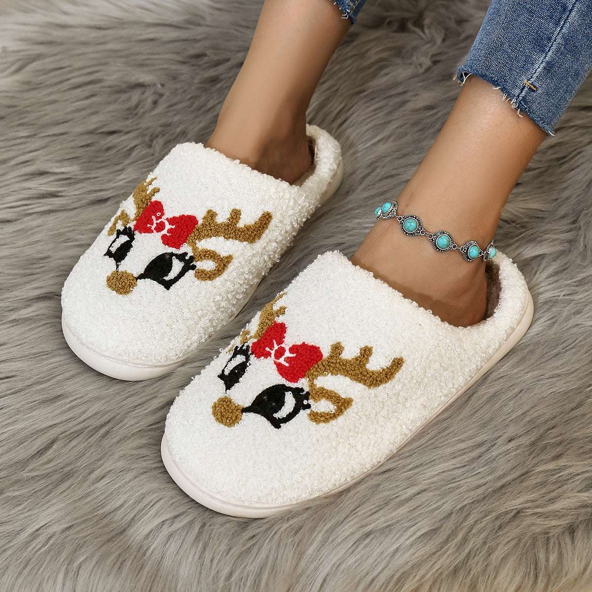 White plush Christmas home slippers with embroidered reindeer face and antlers graphic