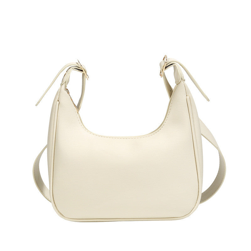 Cream minimalist dumpling crossbody bag with curved front and drawstring-style top ties